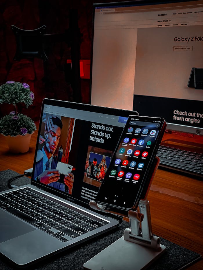 A cozy, modern workspace featuring a laptop and smartphone on a desk, perfect for remote work or digital nomads.