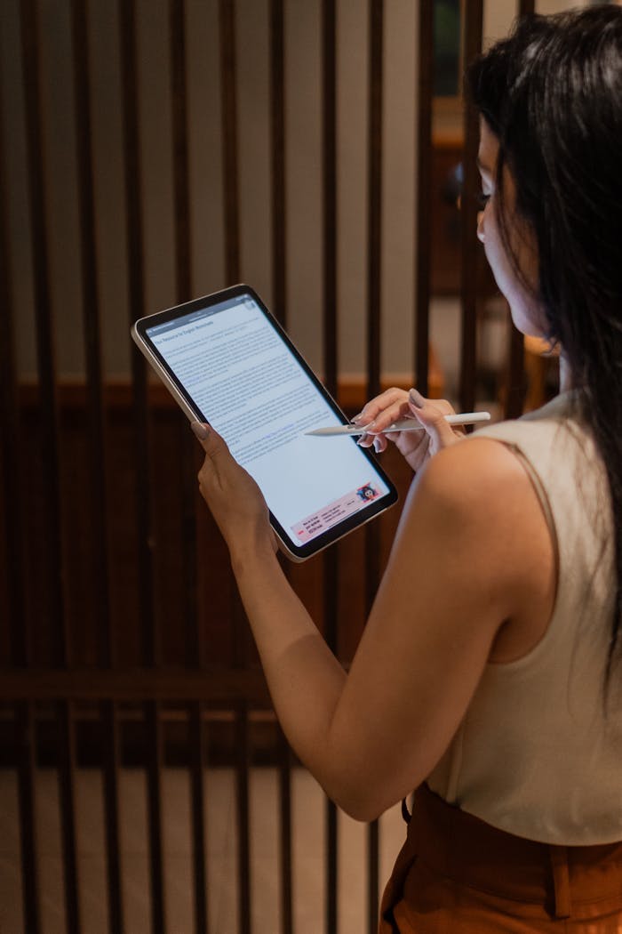 The Art of Drawing Readers In: Your attractive post title goes here Professional woman analyzing a document on a digital tablet in a modern office setting.